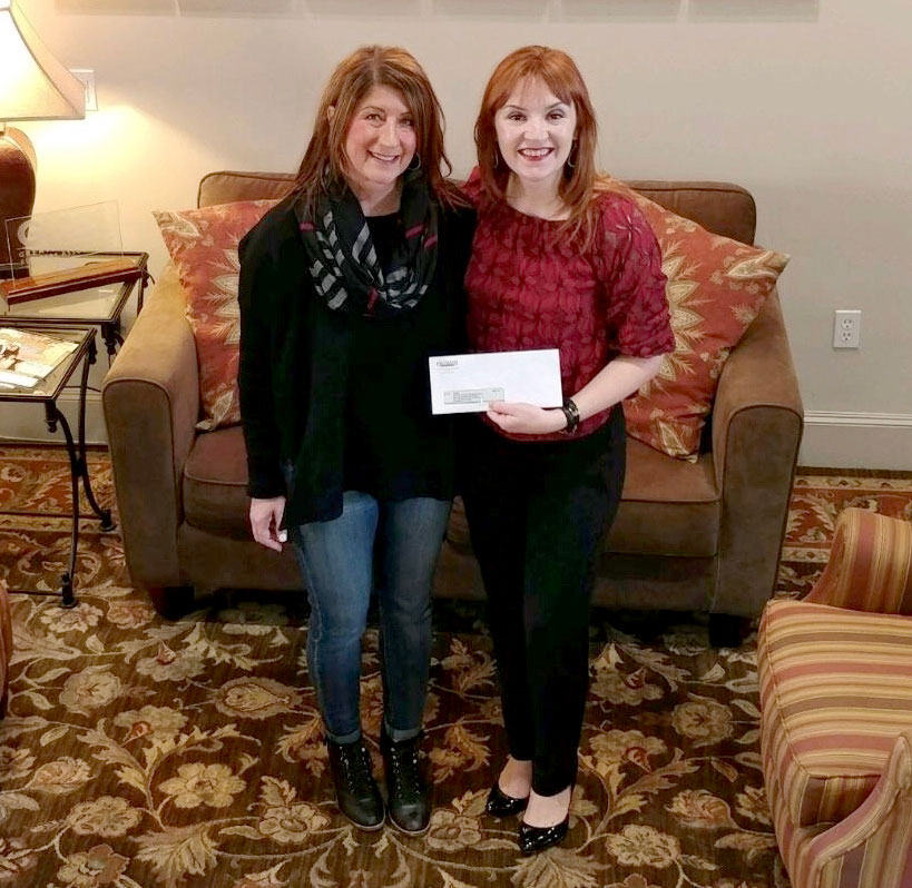 Sindee Cox with Highland Homes (left) presents proceeds from the Benefit Home sale to GHBA CEO Casey Morgan.